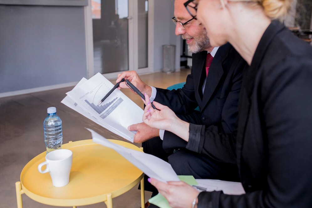 business-man-woman-sitting-desk-talking-about-reports-finance_23-2147923430